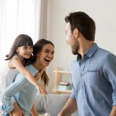 family laughing and playing inside pest free home