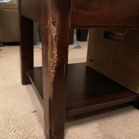 An end table with termite damage
