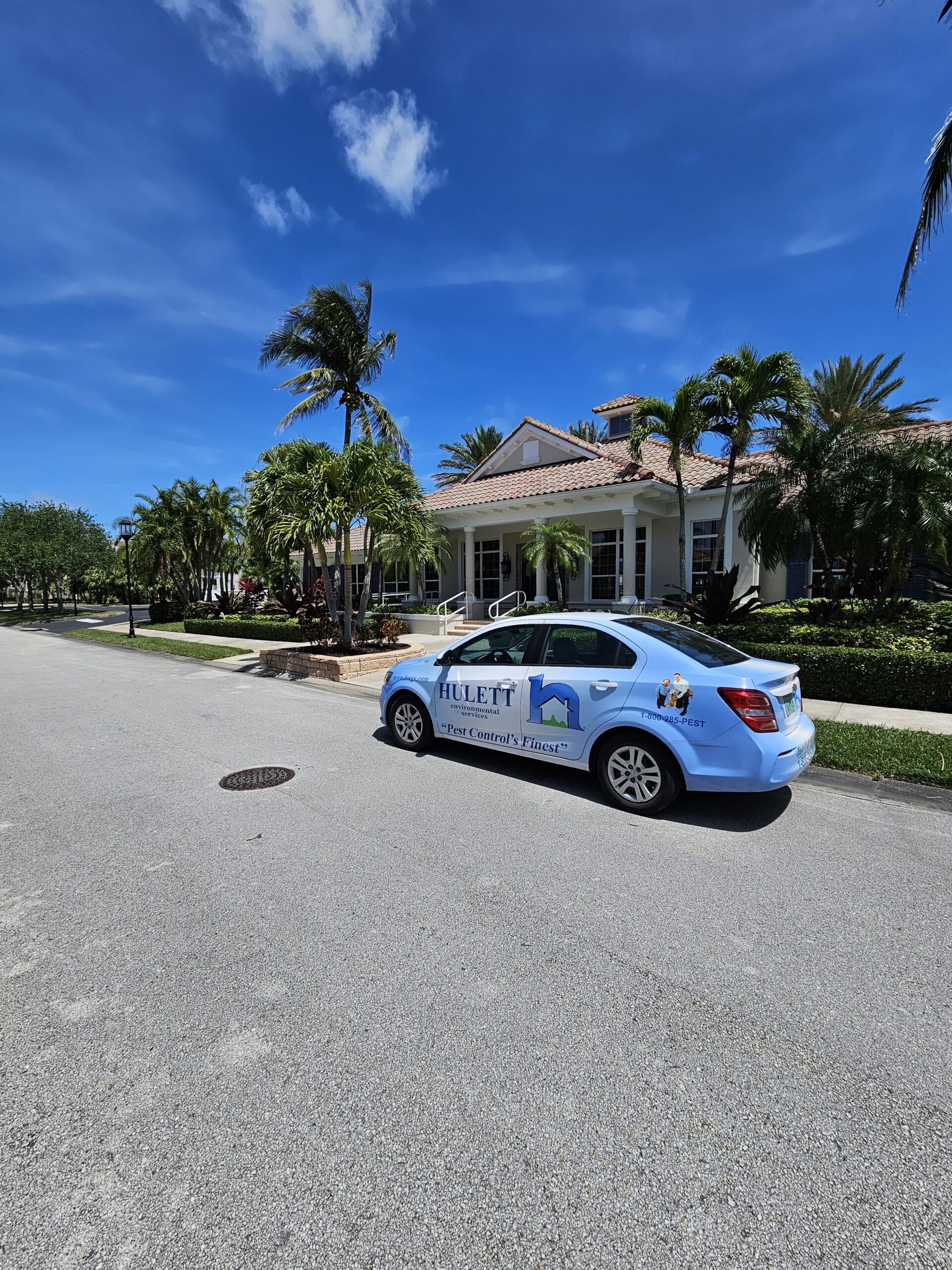 Hulett service car parked in a Vero Beach driveway to provide pest control services. 